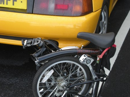Brompton Bicycle by a Lotus Elan