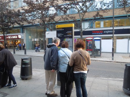 Three Visitors Inspecting A Lith